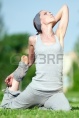 10203877-beautiful-woman-doing-stretching-exercise-on-green-grass-at-park-yoga