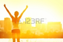 13396263-success-winner-woman-standing-with-arms-up-joyful-after-outdoors-workout-half-silhouette-on-sunny-wa