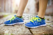 32624412-female-runner-getting-ready-for-training-on-tiled-pavement-in-city-center-closeup-on-shoes